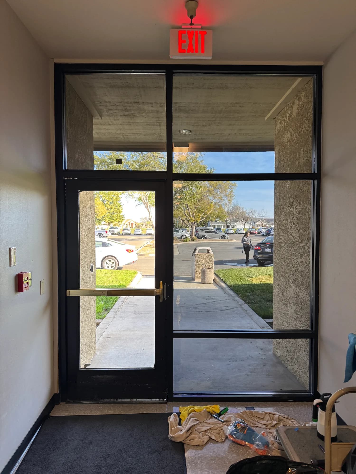 Window film installation in progress on the lobby entry glass of the HSA Building in Merced CA