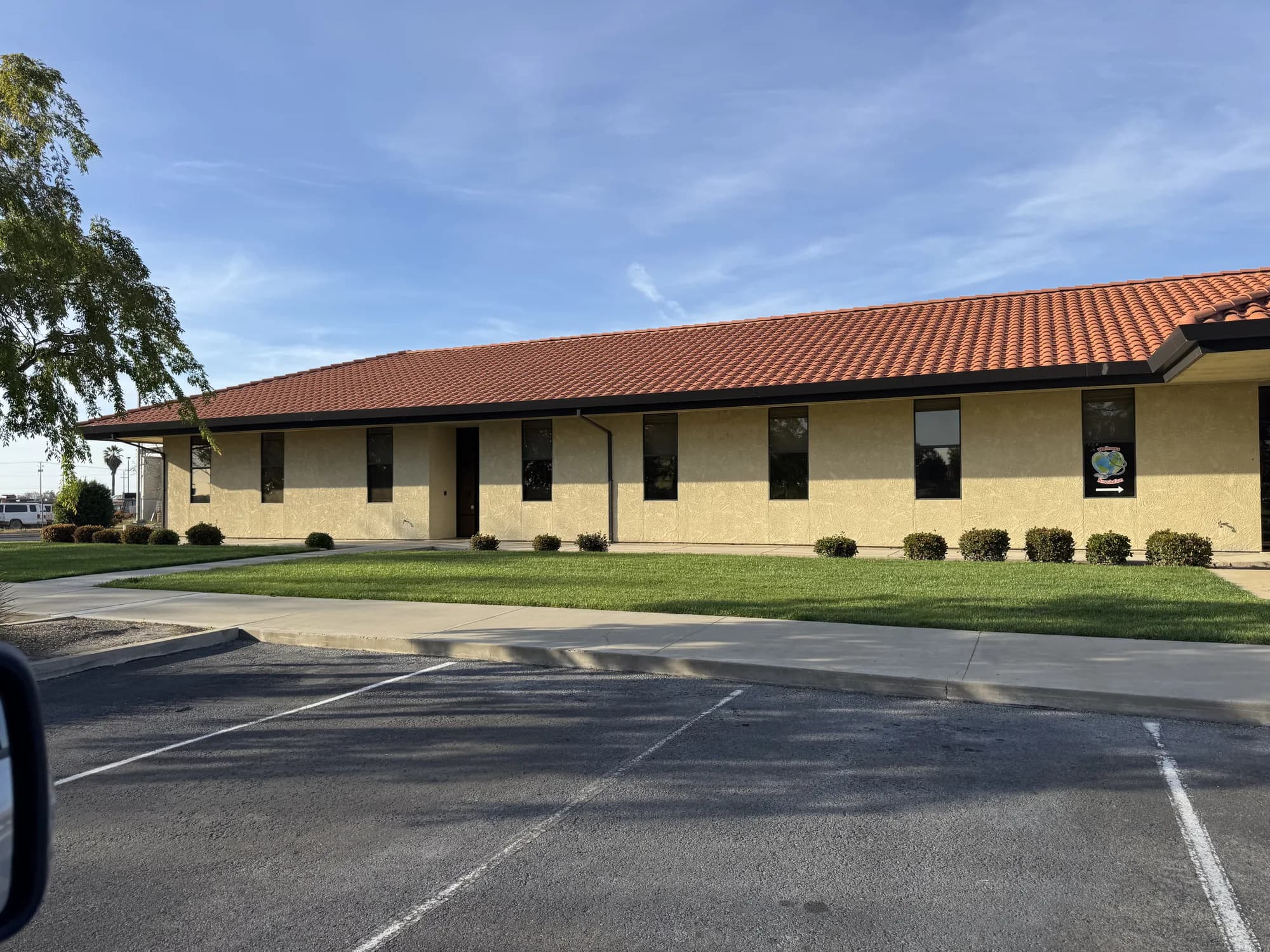 Street view of the tinted office windows along the HSA Building in Merced CA